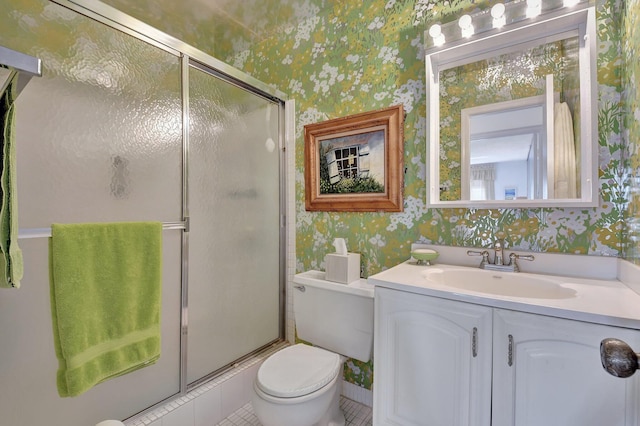 10129 43rd Dr S Unit 311, Boynton Beach, FL 33436 - bathroom featuring wallpapered walls, a stall shower, vanity, toilet, and tile patterned floors