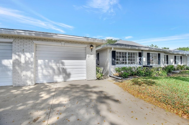 10129 43rd Dr S Unit 311, Boynton Beach, FL 33436 - ranch-style home with brick siding, a garage, and concrete driveway