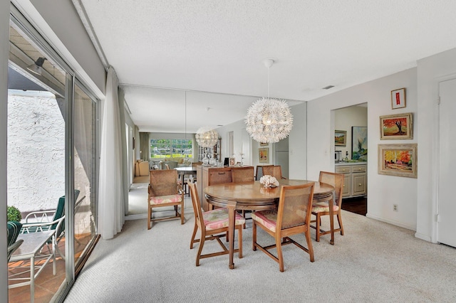 10129 43rd Dr S Unit 311, Boynton Beach, FL 33436 - dining room featuring a chandelier, light colored carpet, baseboards, and a textured ceiling