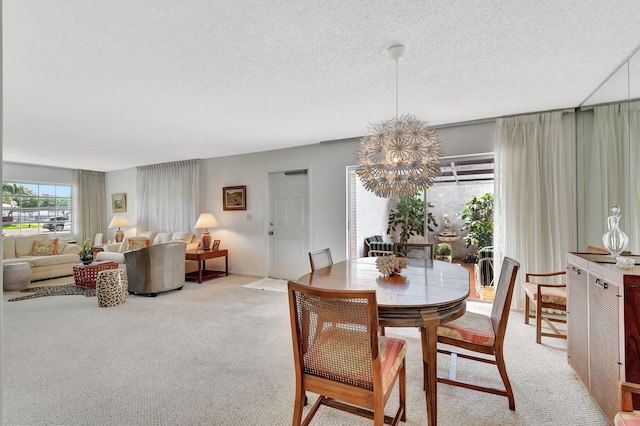 10129 43rd Dr S Unit 311, Boynton Beach, FL 33436 - dining area with light colored carpet, a textured ceiling, and a chandelier