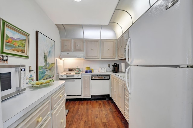 10129 43rd Dr S Unit 311, Boynton Beach, FL 33436 - kitchen featuring white appliances, under cabinet range hood, light countertops, and dark wood finished floors