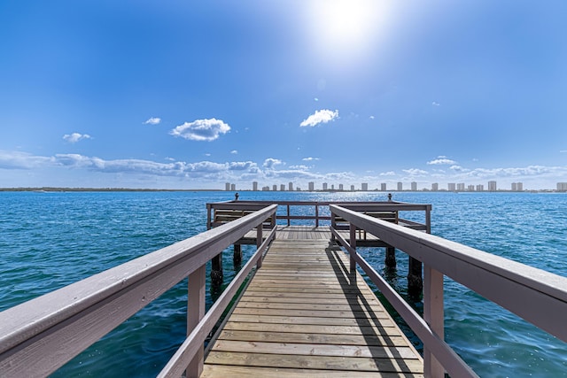 view of dock featuring a water view and a city view