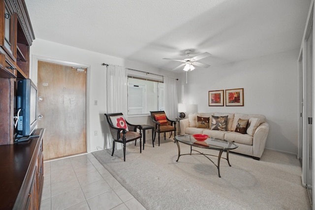living room featuring light tile patterned floors and a ceiling fan