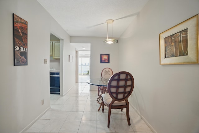 dining area featuring light tile patterned flooring and baseboards