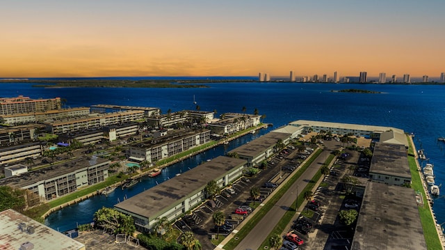 birds eye view of property with a view of city and a water view