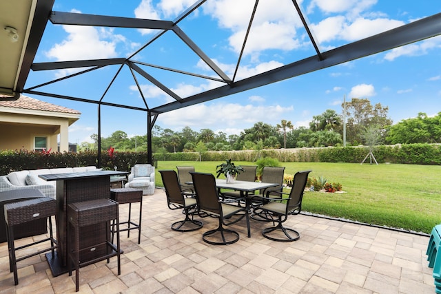 view of patio featuring outdoor dining area and glass enclosure
