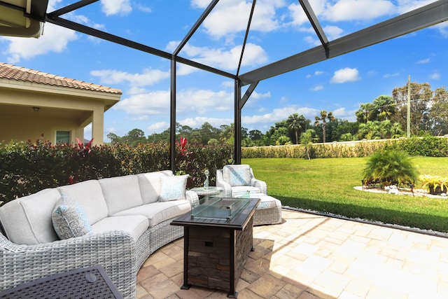 view of patio / terrace with an outdoor living space with a fire pit and glass enclosure