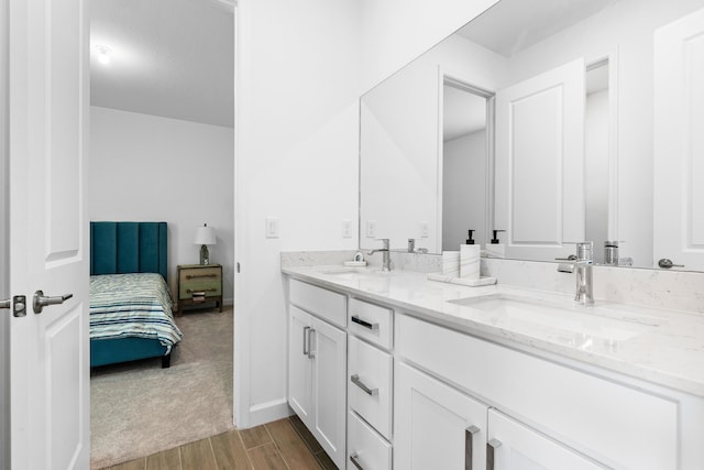 1218 Timber Reap Trl, The Acreage, FL 33470 - full bathroom with double vanity, wood finished floors, baseboards, and a sink