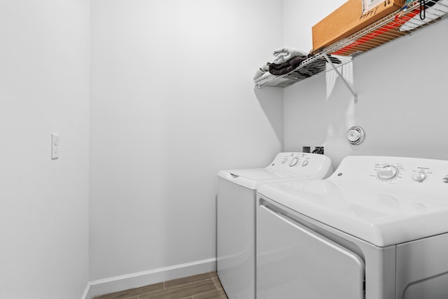 1218 Timber Reap Trl, The Acreage, FL 33470 - clothes washing area featuring washer and dryer, baseboards, wood finished floors, and laundry area