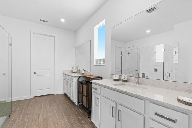 1218 Timber Reap Trl, The Acreage, FL 33470 - bathroom with vanity, wood finished floors, visible vents, and a stall shower