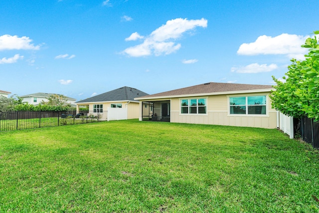 1218 Timber Reap Trl, The Acreage, FL 33470 - back of property with board and batten siding, a lawn, and a fenced backyard