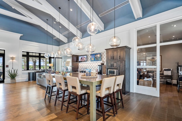 1218 Timber Reap Trl, The Acreage, FL 33470 - dining area featuring a high ceiling, dark wood-style flooring, beamed ceiling, and recessed lighting