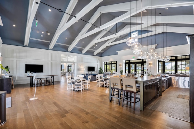 1218 Timber Reap Trl, The Acreage, FL 33470 - dining space featuring beam ceiling, wood finished floors, and high vaulted ceiling