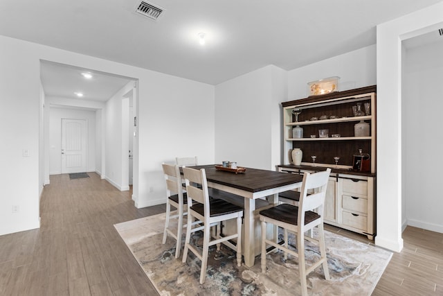 1218 Timber Reap Trl, The Acreage, FL 33470 - dining space with baseboards, light wood-style flooring, and visible vents