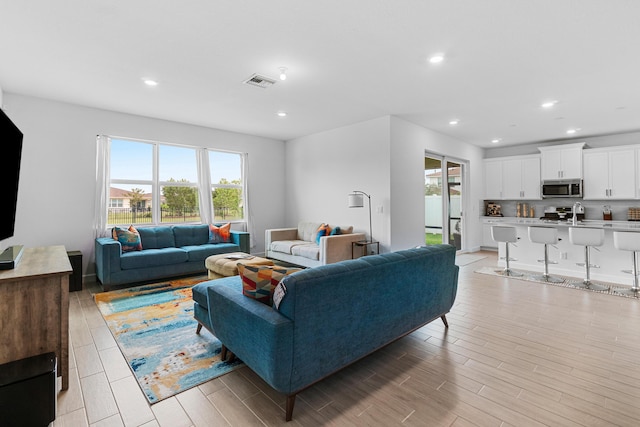 1218 Timber Reap Trl, The Acreage, FL 33470 - living area featuring recessed lighting, light wood finished floors, visible vents, and plenty of natural light