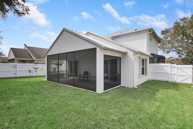 144 Pennock Landing Cir, Jupiter, FL 33458 - back of house featuring a standing seam roof, a sunroom, stucco siding, a gate, and metal roof
