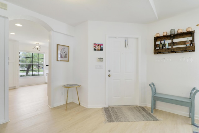 144 Pennock Landing Cir, Jupiter, FL 33458 - foyer with light wood-style flooring, arched walkways, baseboards, and recessed lighting