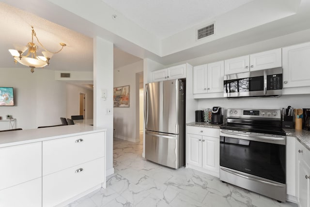 kitchen with a notable chandelier, white cabinetry, visible vents, appliances with stainless steel finishes, and marble finish floor