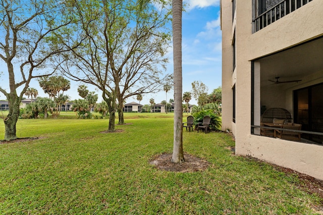 view of yard featuring a ceiling fan