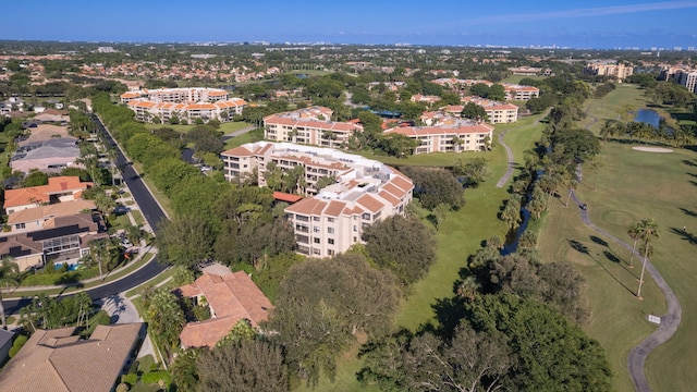 drone / aerial view with view of golf course and a water view