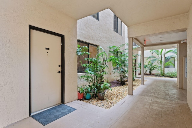 entrance to property featuring stucco siding