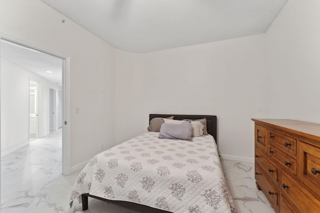 bedroom with marble finish floor and baseboards