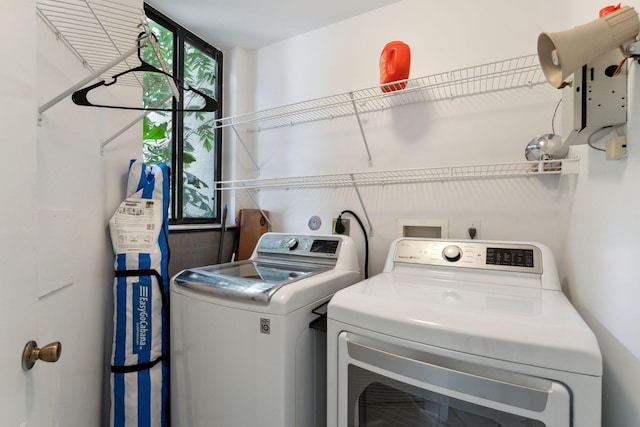 washroom featuring separate washer and dryer and laundry area