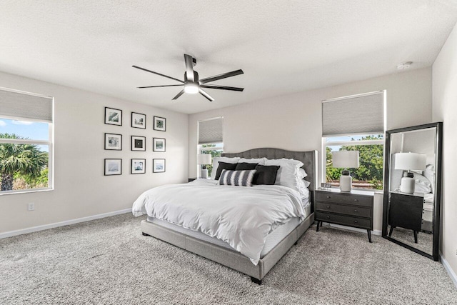 5612 Mentmore Dr, West Palm Beach, FL 33407 - carpeted bedroom featuring multiple windows, baseboards, a ceiling fan, and a textured ceiling