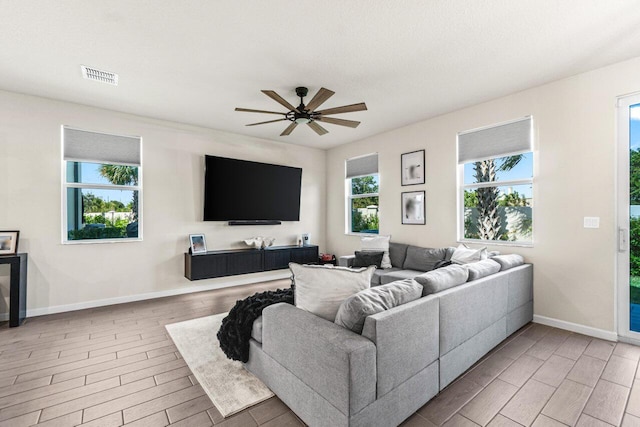 5612 Mentmore Dr, West Palm Beach, FL 33407 - living room featuring wood finished floors, baseboards, and a ceiling fan