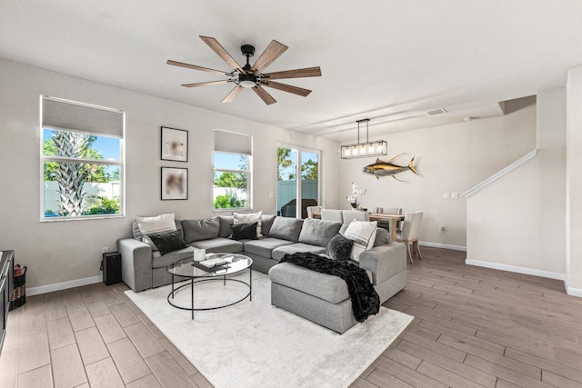 5612 Mentmore Dr, West Palm Beach, FL 33407 - living room featuring light wood-type flooring, baseboards, and ceiling fan