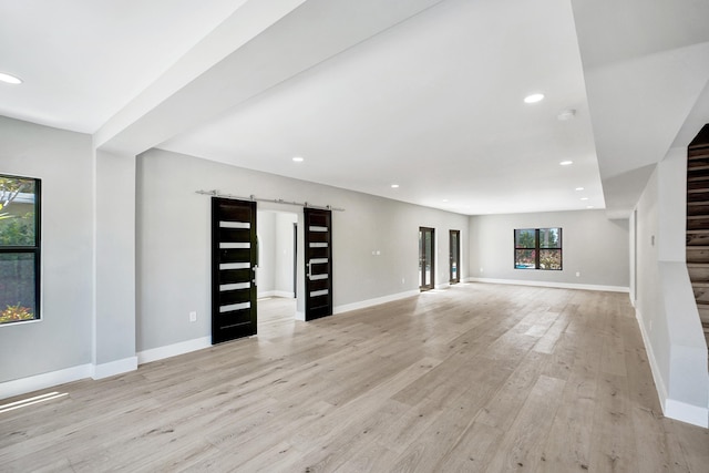 5832 Alton Rd, Miami Beach, FL 33140 - unfurnished living room with baseboards, light wood finished floors, recessed lighting, and stairs