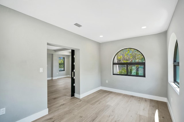 5832 Alton Rd, Miami Beach, FL 33140 - empty room featuring recessed lighting, arched walkways, light wood finished floors, baseboards, and visible vents