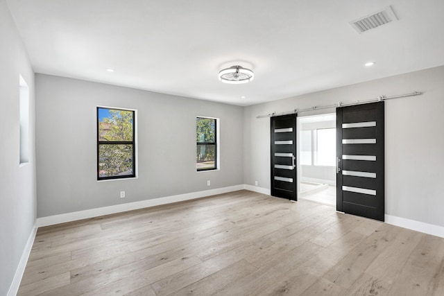 5832 Alton Rd, Miami Beach, FL 33140 - interior space featuring visible vents, light wood-type flooring, a healthy amount of sunlight, and baseboards