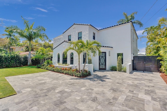 5832 Alton Rd, Miami Beach, FL 33140 - view of front of home with a gate, fence, stucco siding, and a tile roof