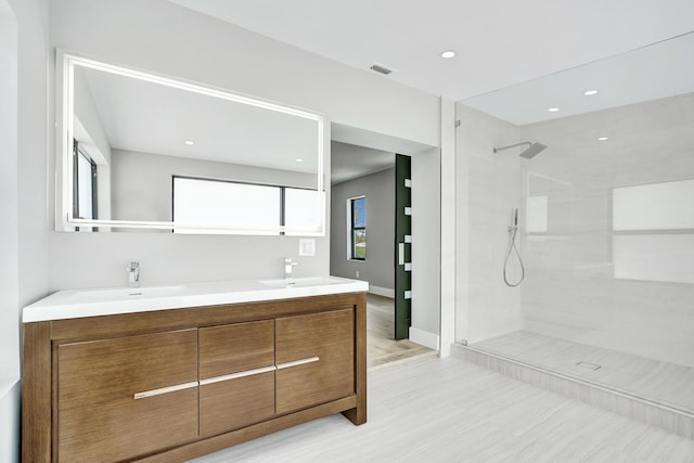 5832 Alton Rd, Miami Beach, FL 33140 - bathroom featuring visible vents, walk in shower, double vanity, and a sink