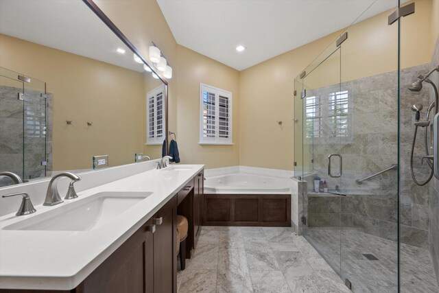 bathroom featuring a shower stall, a bath, double vanity, and a sink