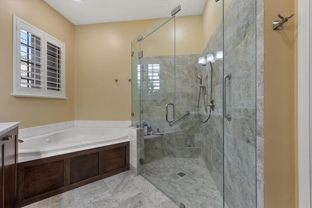 bathroom with a bath, a stall shower, and vanity