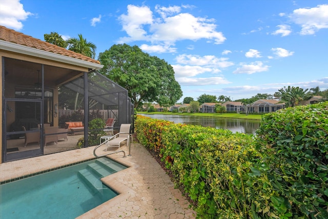 outdoor pool featuring a lanai, a patio, and a water view