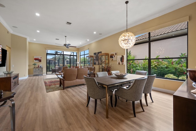 dining space with visible vents, baseboards, crown molding, and light wood-style flooring