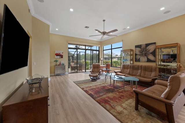 living area with ornamental molding, recessed lighting, visible vents, ceiling fan, and wood finished floors