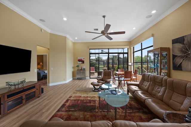 living area featuring crown molding, baseboards, recessed lighting, and wood finished floors