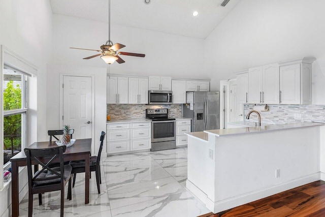 12820 Smithdale Pl, Boca Raton, FL 33428 - kitchen featuring a peninsula, white cabinetry, a ceiling fan, appliances with stainless steel finishes, and a sink