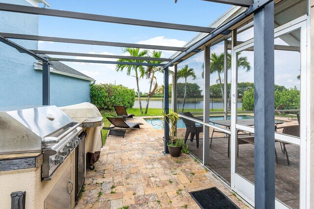 12820 Smithdale Pl, Boca Raton, FL 33428 - view of patio with a grill, a water view, area for grilling, a fenced in pool, and a lanai