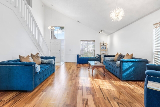 12820 Smithdale Pl, Boca Raton, FL 33428 - living area with high vaulted ceiling, light wood finished floors, a chandelier, and stairs