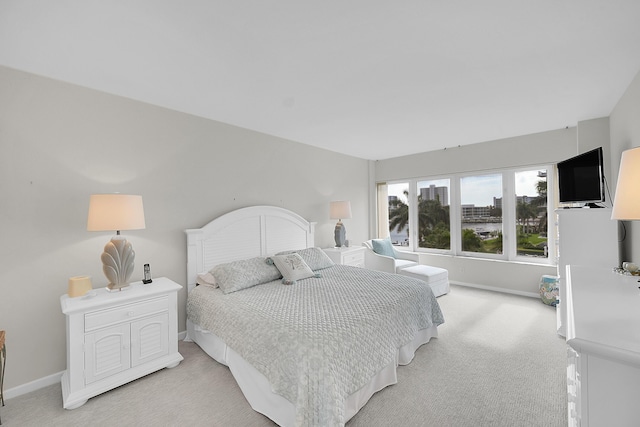 701 E Camino Real Unit 4B, Boca Raton, FL 33432 - bedroom featuring light carpet and baseboards