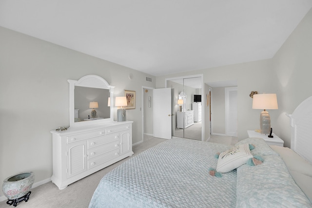 701 E Camino Real Unit 4B, Boca Raton, FL 33432 - bedroom with light colored carpet, a closet, and baseboards