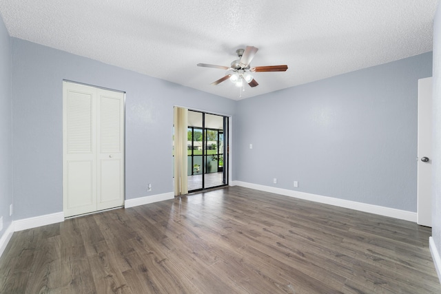 empty room with wood finished floors, ceiling fan, and baseboards