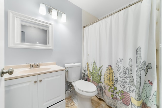 bathroom with toilet, tile patterned floors, curtained shower, and vanity