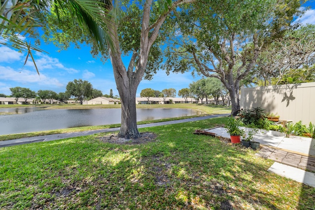 view of yard featuring a water view and fence