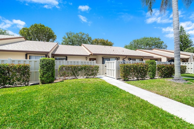view of front of home featuring a front yard, a gate, and a fenced front yard